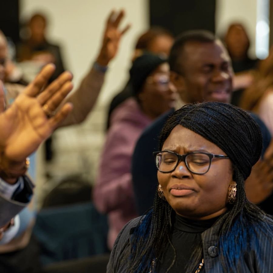 Worshippers praying with raised hands